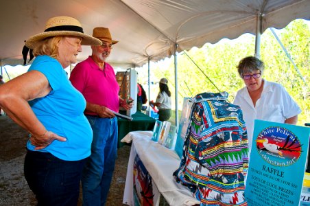 Jane and Peter talk with Thais who has helped organize the White Pelican Celebration at Smallwoods January 6-8