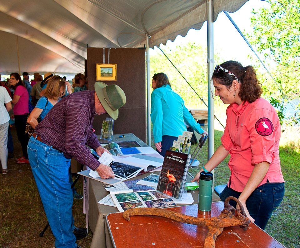 Lynwood examines old Life and Look magazines about the logging and preserving the Corkscrew Swamp area organized by Ginger on right
