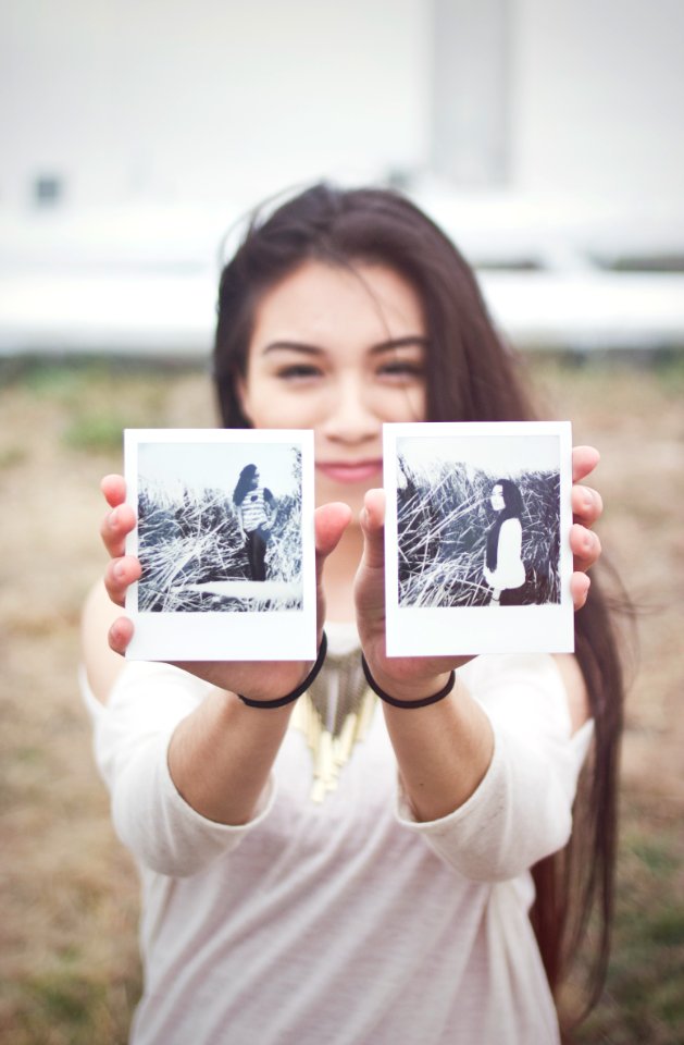 Girl Holding Polaroids