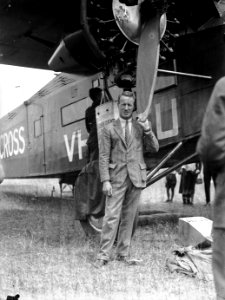 143; Kingsford-Smith standing next to aeroplane, the Southern Cross, Rongotai - 1933