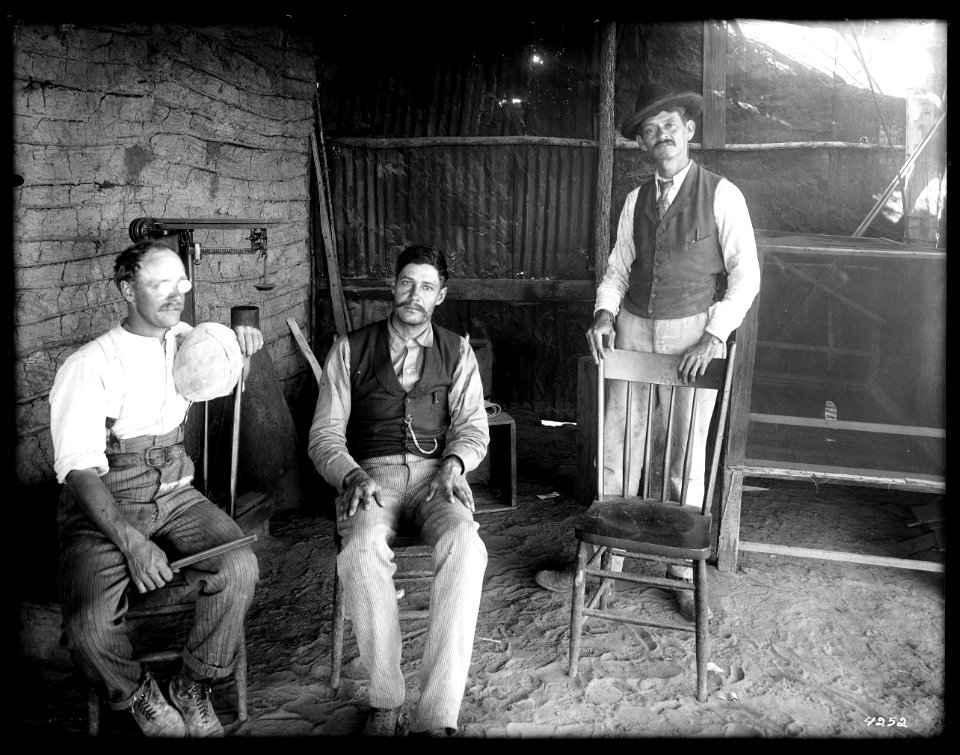Three men in the Mexican Custom House, just below the first heading of the Colorado River, near Mexicali, ca.1910 (CHS-4252)