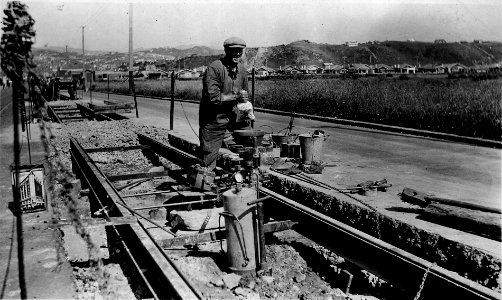 200; Broadway, workman filling Crucible with Thermit Welding Portion - 20 Jan 1936