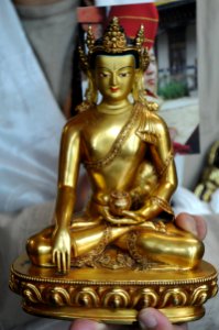 Buddha ku or statue, earth touching mudra, at the empowerment of Rangjung Padma'i Nyingthig, Spontaneously Occurring Heart Essence of Padma Empowerment by Dilgo Khyentse Yangsi Rinpoche, (photo of Dilgo Yangsi in background), Tibetan Buddhism, Canada