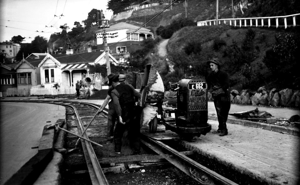 31; Aro Street, workmen pouring concrete out of tipper on Lister Truck, between newly laid tram rails - 13 Jun 1930