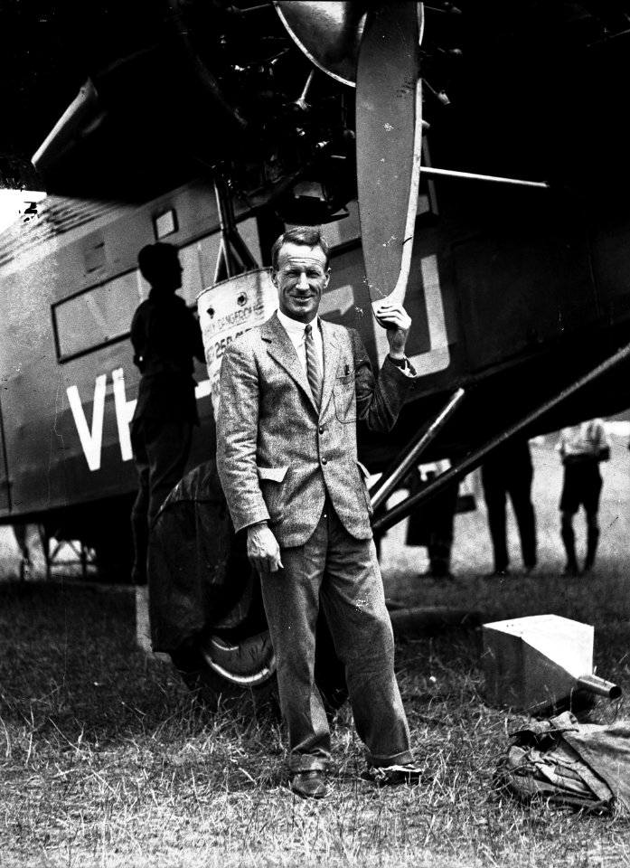 126; Kingsford-Smith standing next to aeroplane, the Southern Cross, Rongotai - 1933