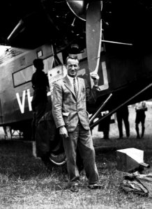 126; Kingsford-Smith standing next to aeroplane, the Southern Cross, Rongotai - 1933