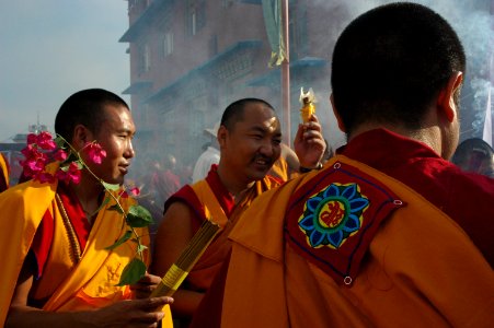 Colorful Lotus Patch, formal robes of delighted monks bearing flower and incense offerings, Bodhisattva Day, Tharlam Monastery Courtyard, Boudha, Kathmandu, Nepal photo