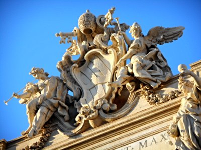 Coat of arms of the Pope Clemente XII between two figures of Fame (1736) - Sculptor Paolo Benaglia - The fountain of Trevi (1732-1762) in Rome photo