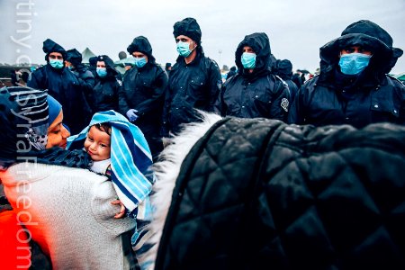 A woman and her baby wait for a bus that will take them to the center for asylum seekers near Roszke, southern Hungary, Sept. 10, 2015.