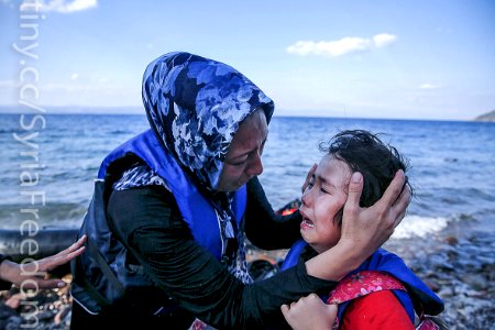 An Afghan mother comforts her crying child moments after a dinghy carrying Afghan migrants arrived on the island of Lesbos, Greece. photo