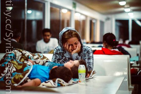 A refugee sleeps with her children on a ferry traveling from the northeastern Greek island of Lesbos to the Athens port of Piraeus, Sept. 9, 2015. photo