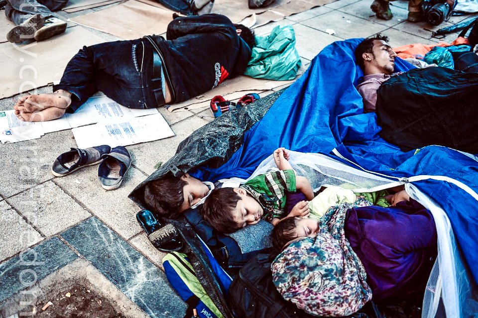 Refugees sleep in a central square in Athens