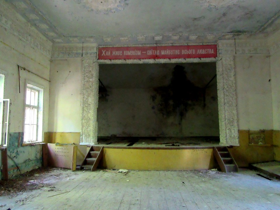Abandoned Community Center in Zalissya Village Sign says something like let communisim live a bright future of all mankind Chernobyl exclusion zone Ukraine