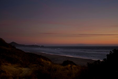 Moolack beach and lighthouse, at sunset, Oregon photo