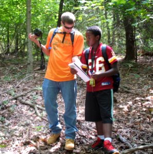 Camper compares notes with one of the counselors
