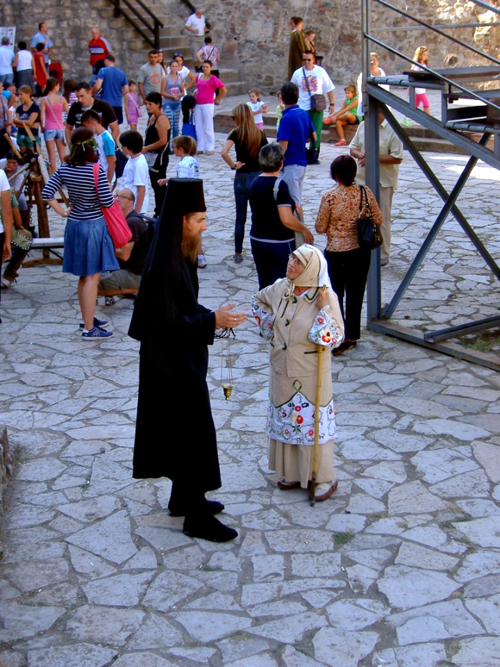 Ortodox Preacher and Woman are Talking before the Show