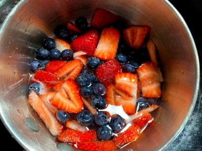 Blueberries and Strawberries cooking in a sauce pan