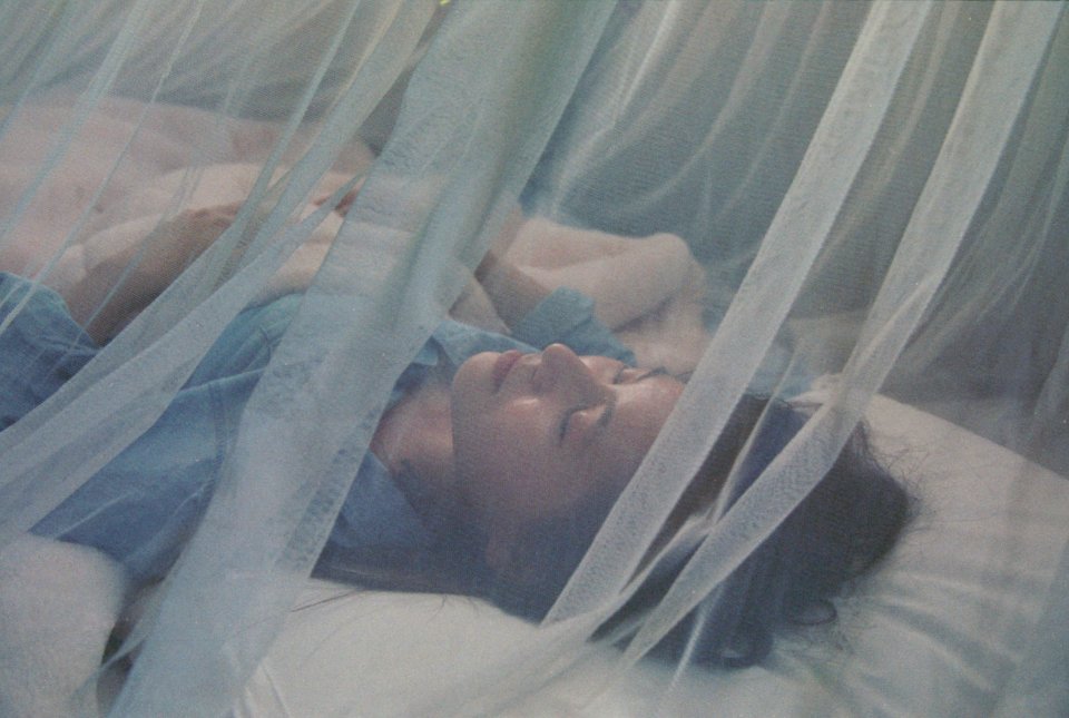 sleeping under mosquito net