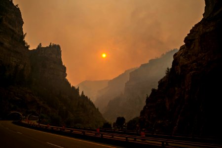 Smoke from the Grizzly Fire turns the setting sun red in Glenwood Canyon