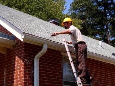 Cyrus Brame cleaning gutters