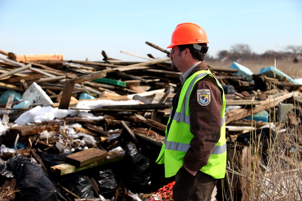 Wildlife biologist Robin Donohue surveys the debris field at Lido Beach WMA.