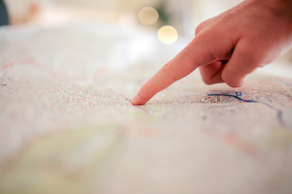 Pointing hand brown map
