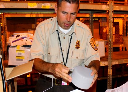 Inspector examines shipment at Newark International Airport photo