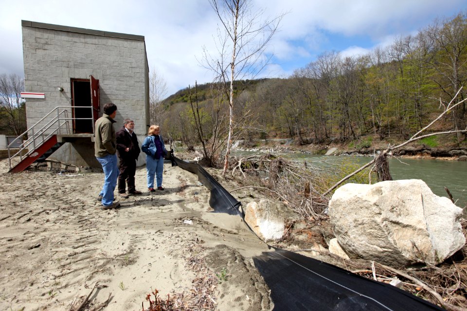 Director Dan Ashe views damage at the hatchery along the White River.