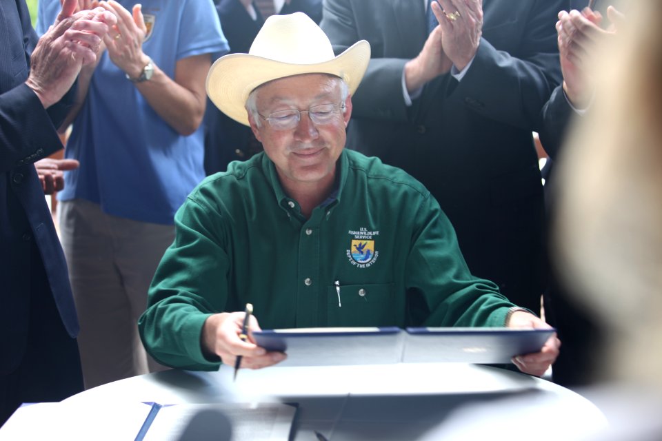 Ken Salazar happy signing