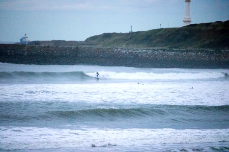 Surfers on Aberdeen Harbour in the Evening photo