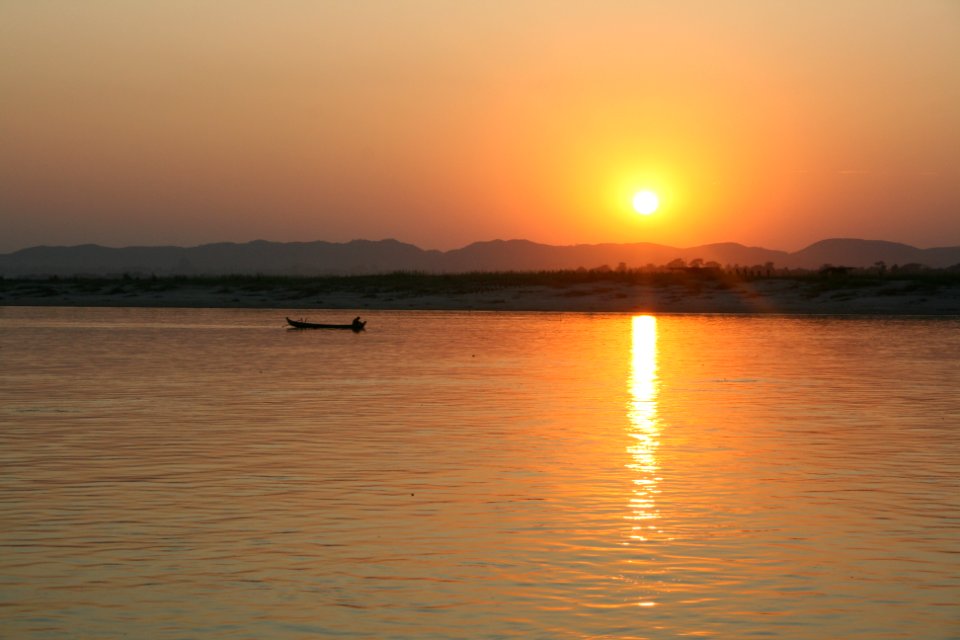 the red sun sinks at last into the hills of gold