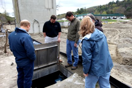 Dan Ashe and staff view damaged plumbing