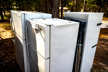 Three Old Refrigerators Sitting Outside