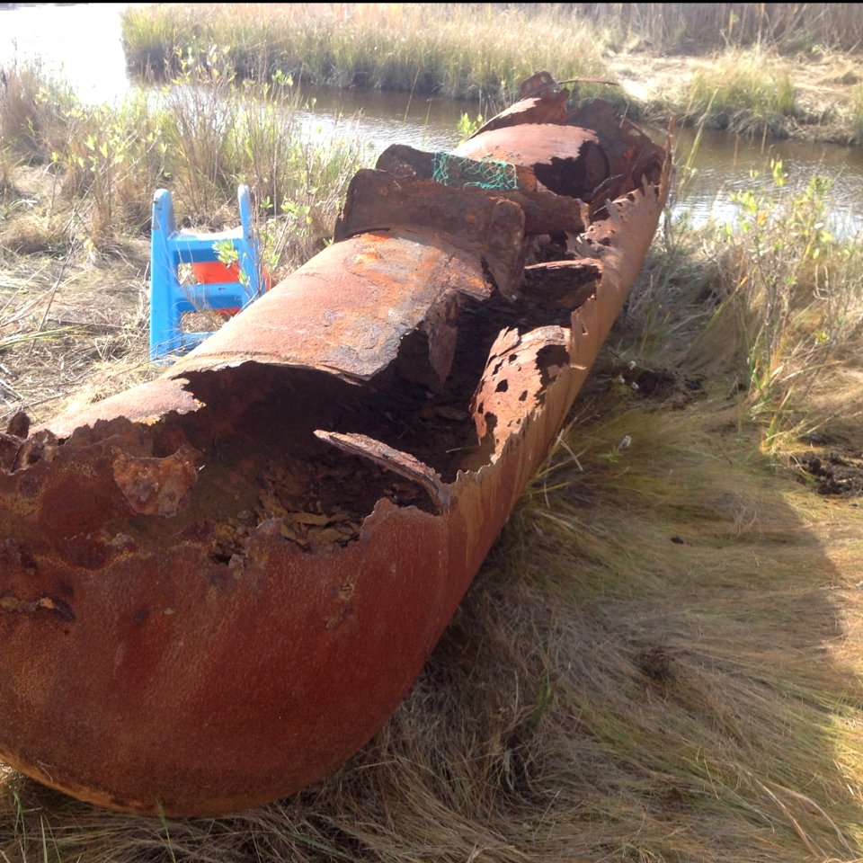 A rusty oil tank removed from the refuge