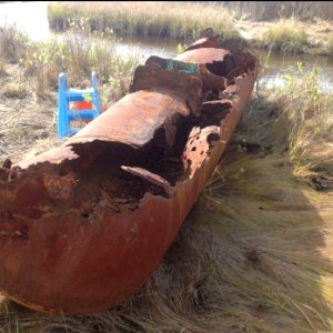 A rusty oil tank removed from the refuge