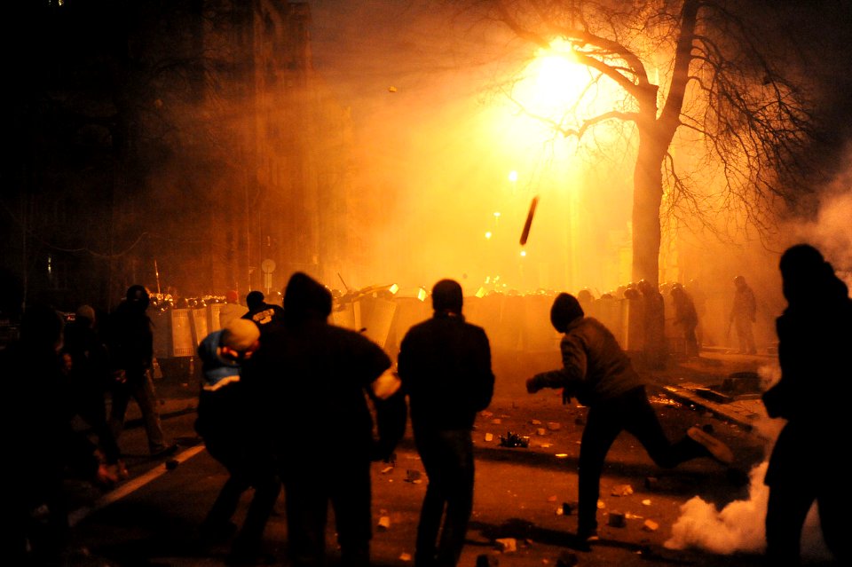 Protesters throwing pieces of paving during and metal tubes at riot police during clashes at Bankova str, Kiev, Ukraine. December 1, 2013
