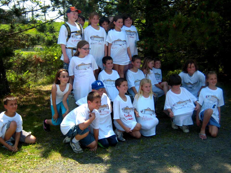 Students pose for picture with t-shirts
