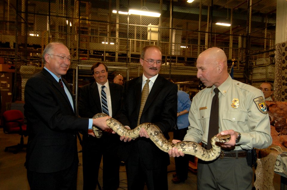 Department of the Interior employees holding a boa constrictor