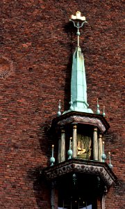Mini bell tower on brick wall