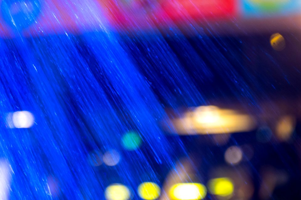 Luminescent blue fountain spray in motion.
