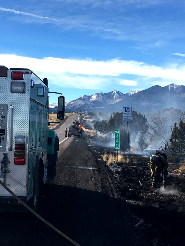U.S. Forest Service firefighter and Arizona State firefighters mop up the "89 Fire," a 50 acre fire on the shoulder of southbound U.S. Highway 89 north of Flagstaff.