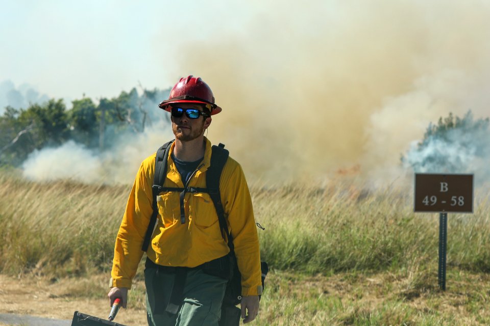Ranger Jordan inspects a prescribed burn