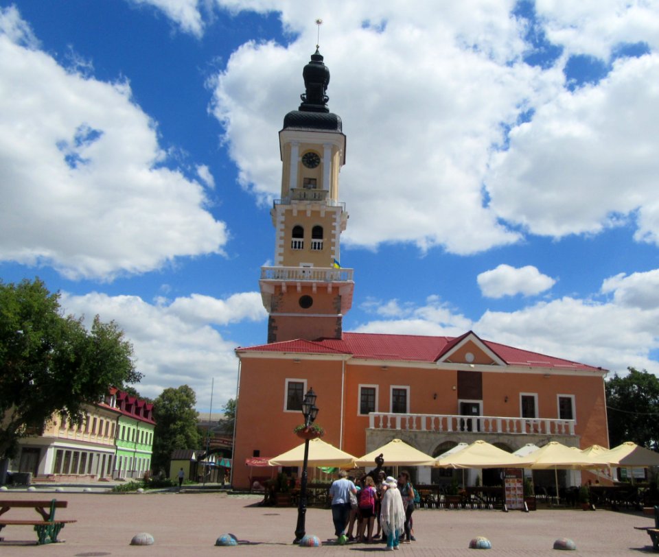 Town Hall Ratusha and People messing with TOurist statue Kamyanets-Podilsky Ukraine