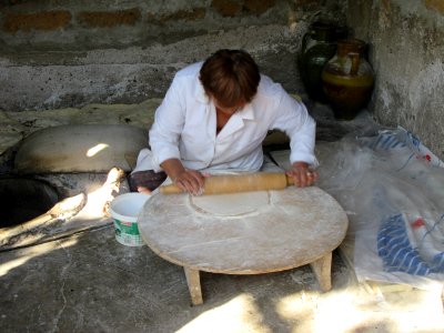 Woman rolling at Lavash at her house Armenia
