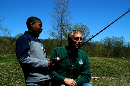 Regional Director Tom Melius Chats with Student About Fishing Experiences photo