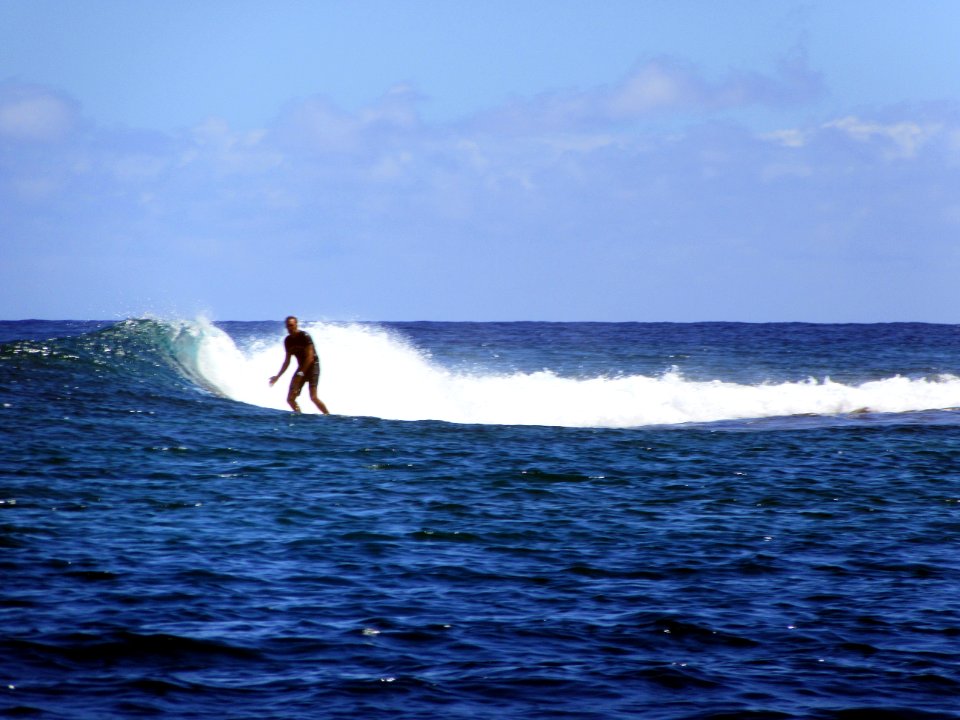 Surfer off of Opunohu Bay Moorea