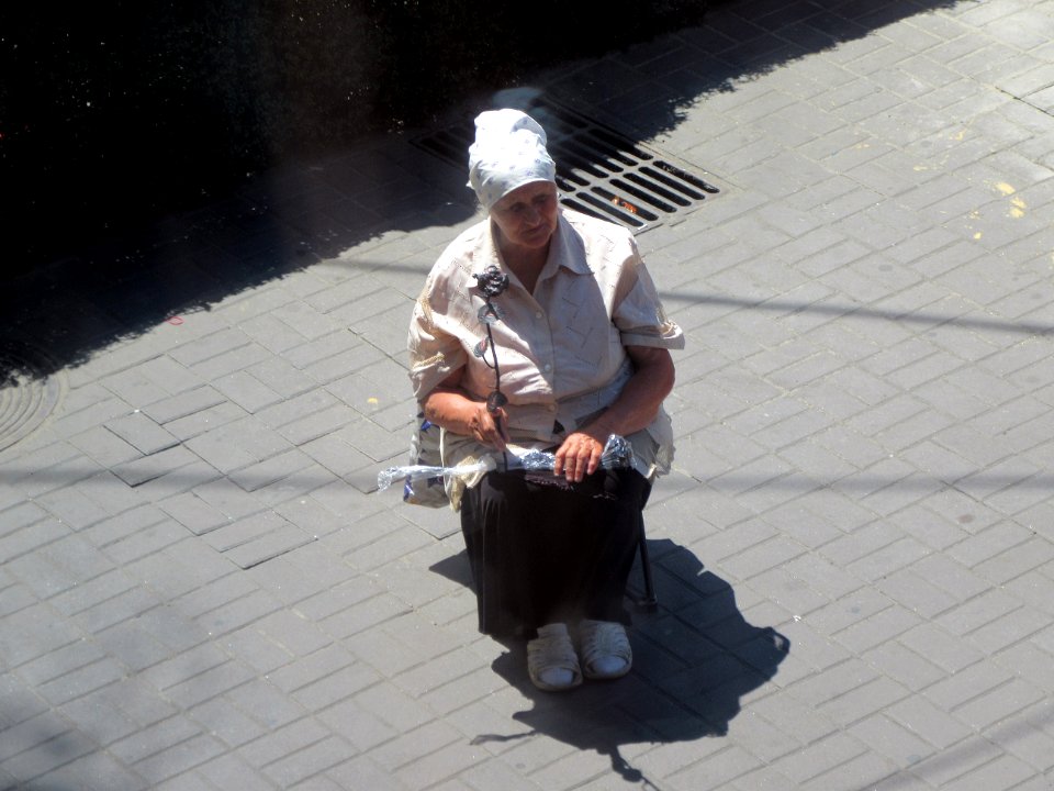Woman selling plastic rose Kiev Ukraine