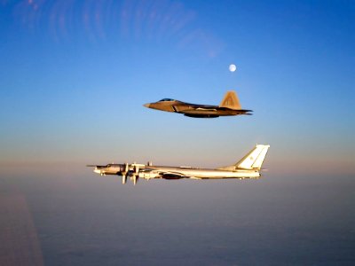 A 90th Fighter Squadron Lockheed Martin F-22A "Raptor" escorts a Russian TU-95 "Bear-H" flying near the Alaskan NORAD Region airspace Nov. 22, 2007.