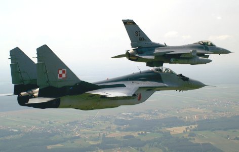 General Dynamics F-16C Fighting Falcon from the 183d Fighter Wing, Illinois ANG, flies in formation with a Polish Mikoyan-Gurevich MiG-29A. photo