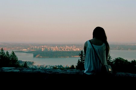 Girl Sitting Looking out at the Sunset photo